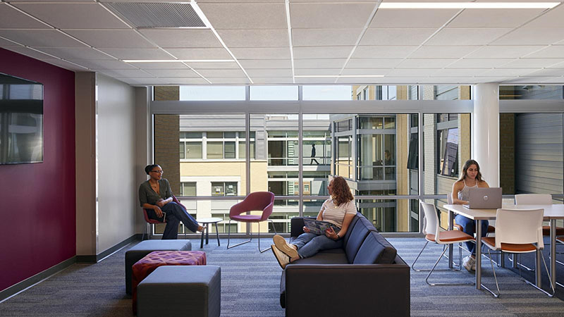 Students seated in the floor lounge at the Living and Learning Commons ELS student residence at Saint Joseph's University in Philadelphia, Pennsylvania, USA.