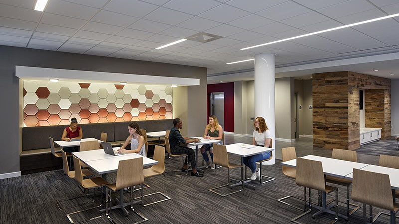 Students seated in the lobby at the Living and Learning Commons ELS student residence at Saint Joseph's University in Philadelphia, Pennsylvania, USA.