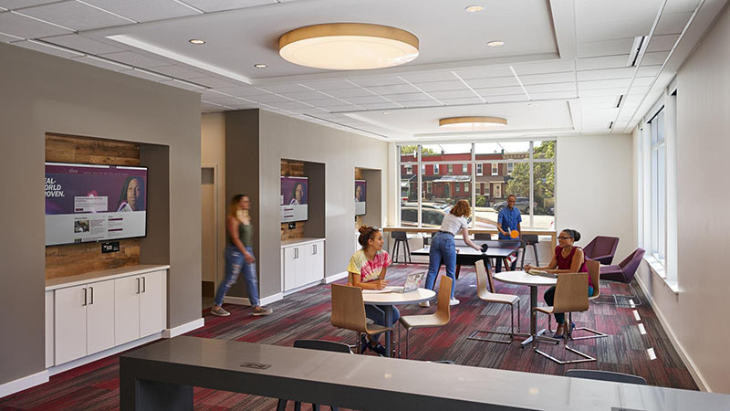 Students seated in the lounge at the Living and Learning Commons ELS student residence at Saint Joseph's University in Philadelphia, Pennsylvania, USA.