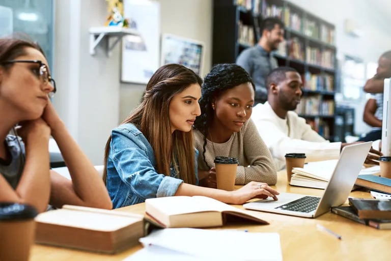 students_looking_at_computer_in_group