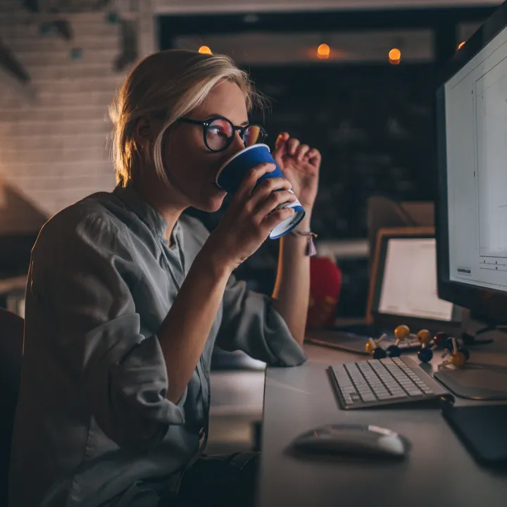 Woman-drinking-coffee-while-working-on-the-computer