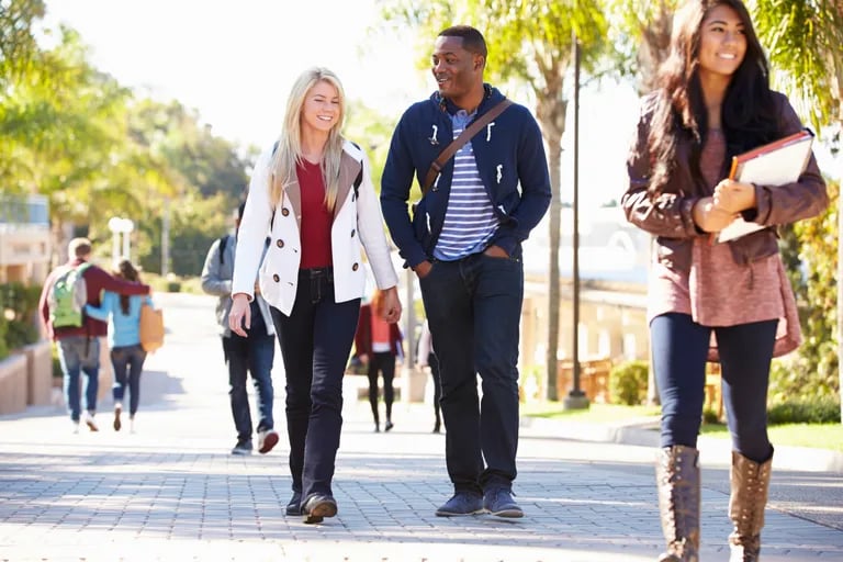 three-students-walking-around-campus
