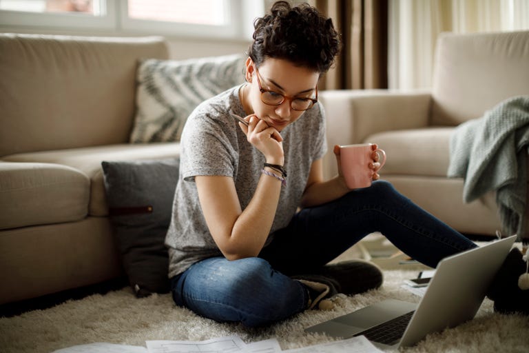 A female English language student working on her laptop from her student accommodation in the USA