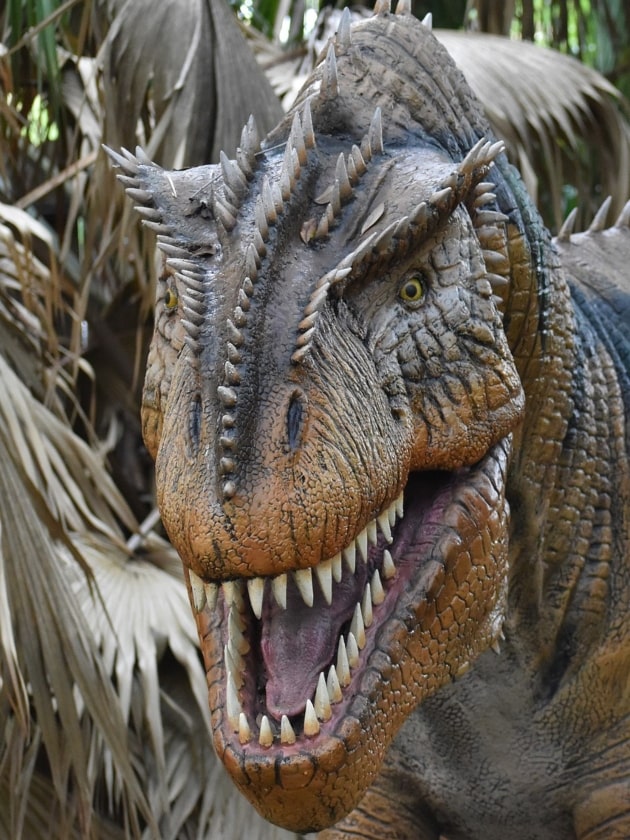 An image of a dinosaur bearing its teeth.
