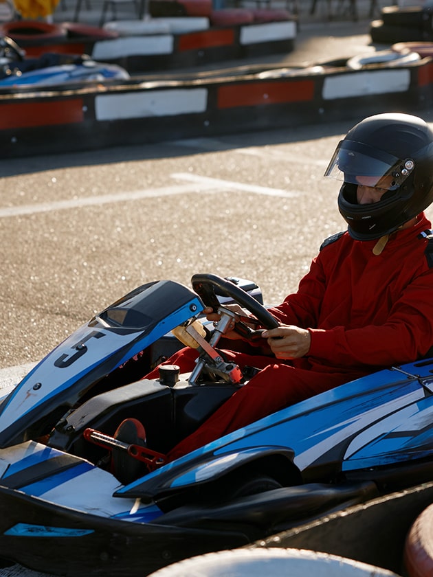 A person driving a go-kart at Andretti Thrill Park in Melbourne, Florida, USA near ELS Language Centers.