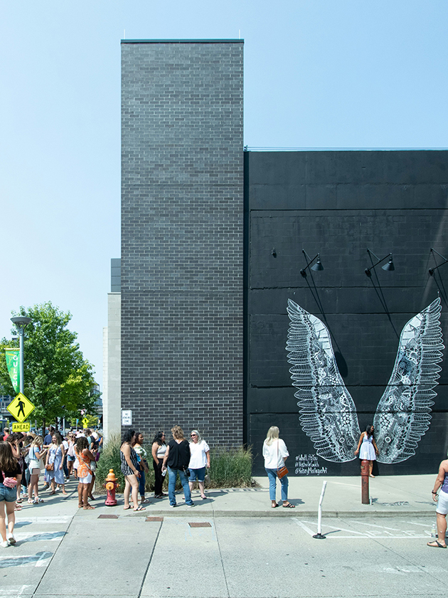 People gathered around a mural in the Gulch neighborhood in Nashville, Tennessee, USA near ELS Language Centers.